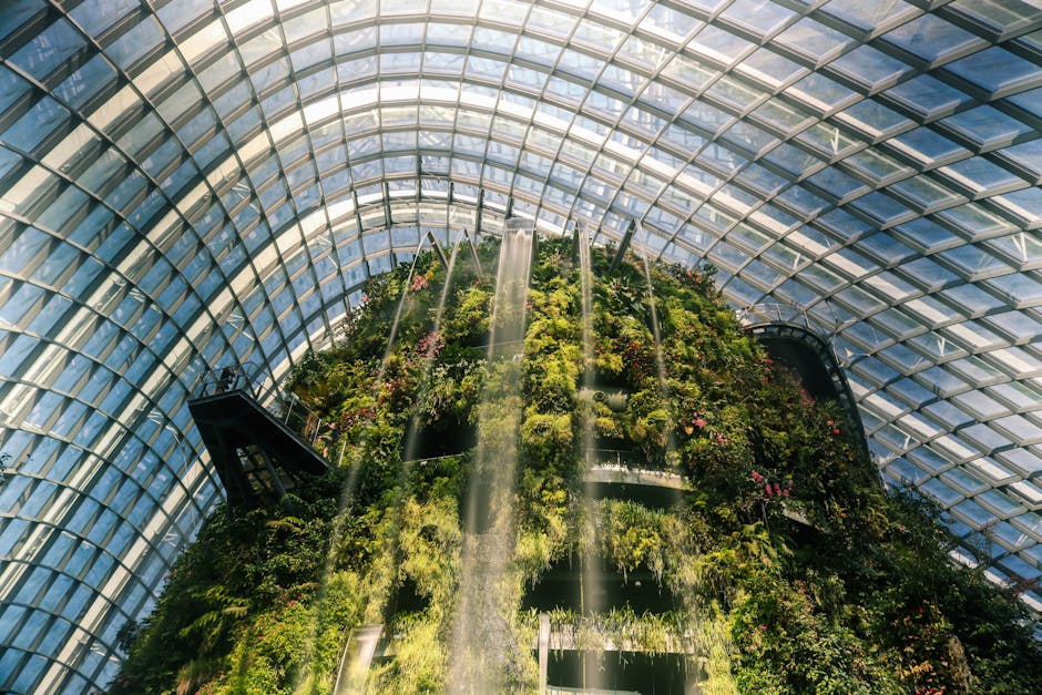 Explore the majestic indoor waterfall surrounded by lush greenery in Singapore's Gardens by the Bay.